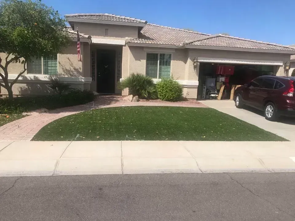 Drought-tolerant front yard landscaping with agave boulders and desert plants in Arizona