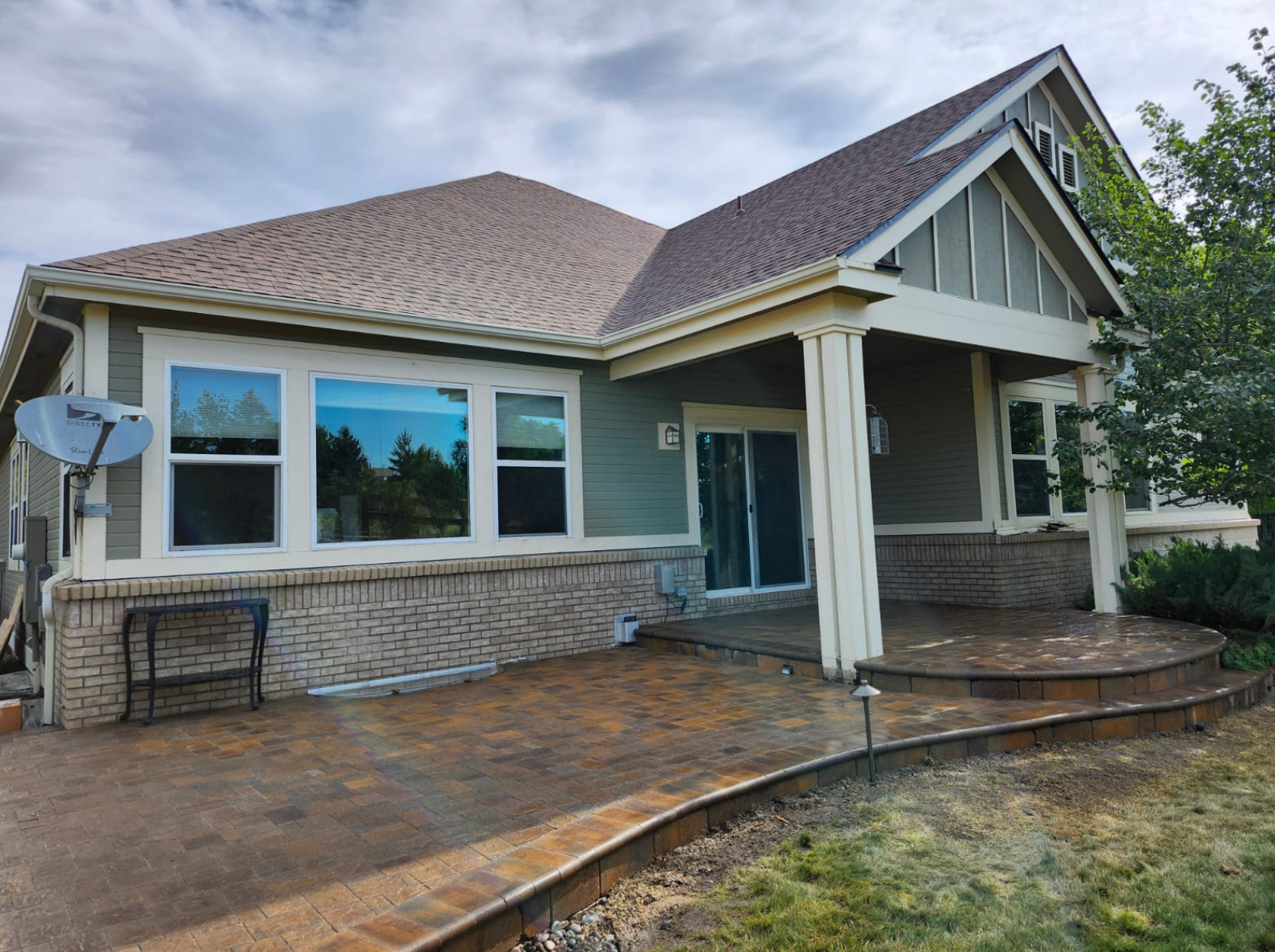 A house with a satellite dish on the side of it.