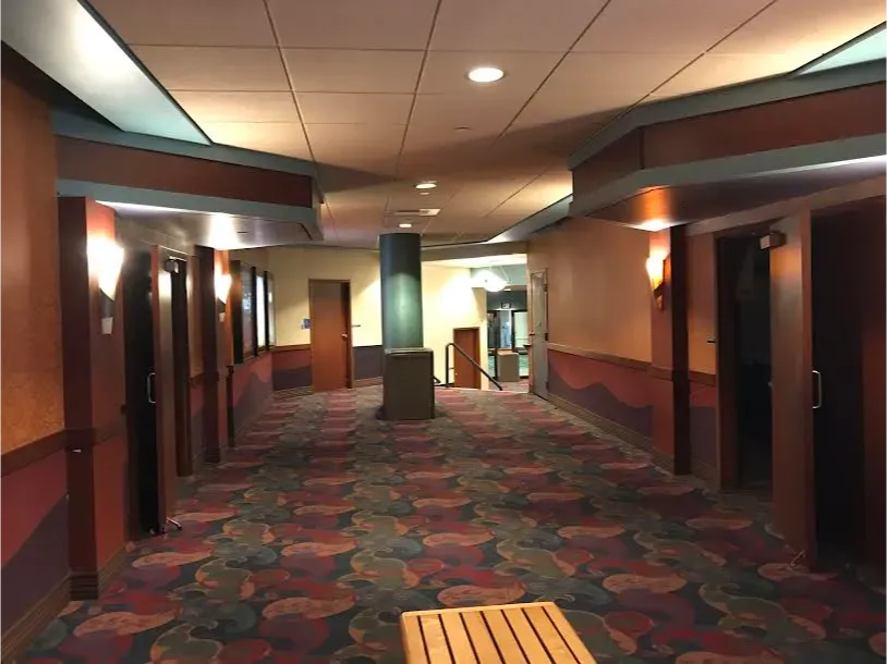 A long hallway with a wooden bench in the middle