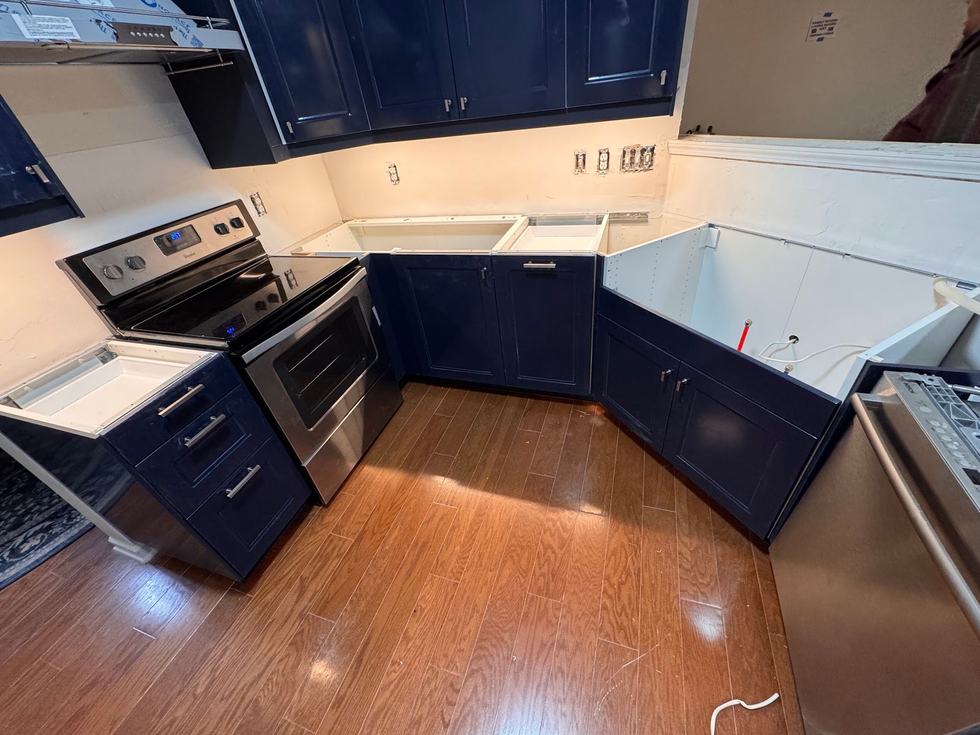 A kitchen with blue cabinets and stainless steel appliances