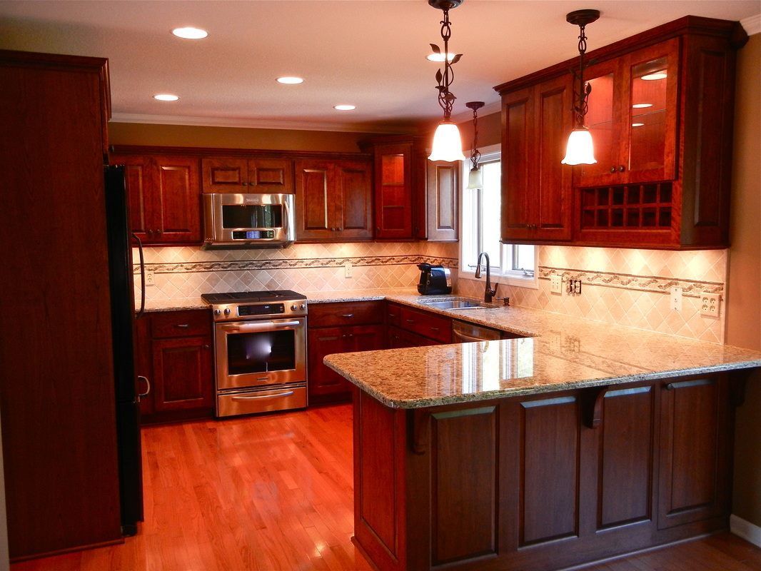 A kitchen with wooden cabinets and granite counter tops