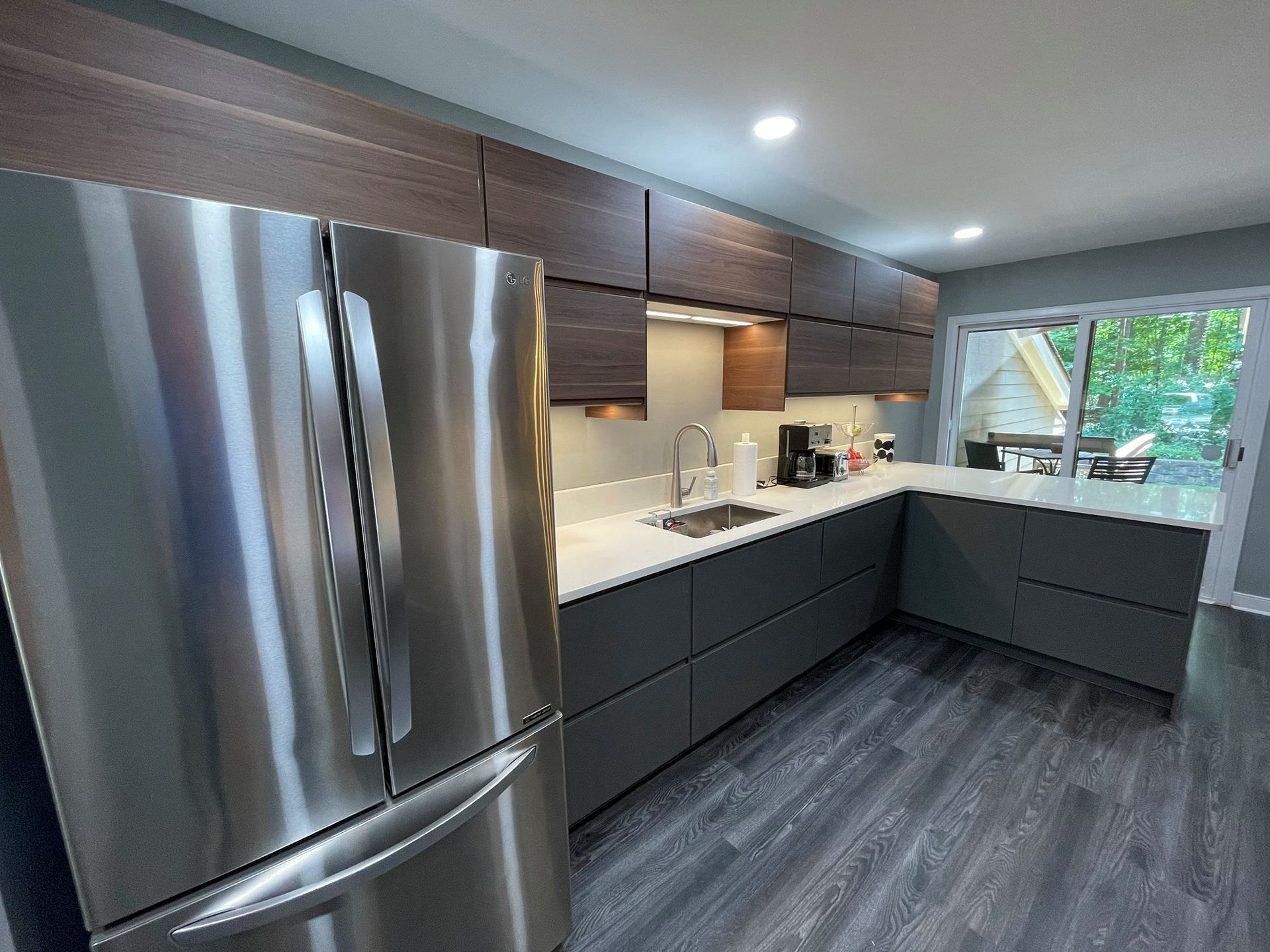 A kitchen with stainless steel appliances and wooden cabinets.