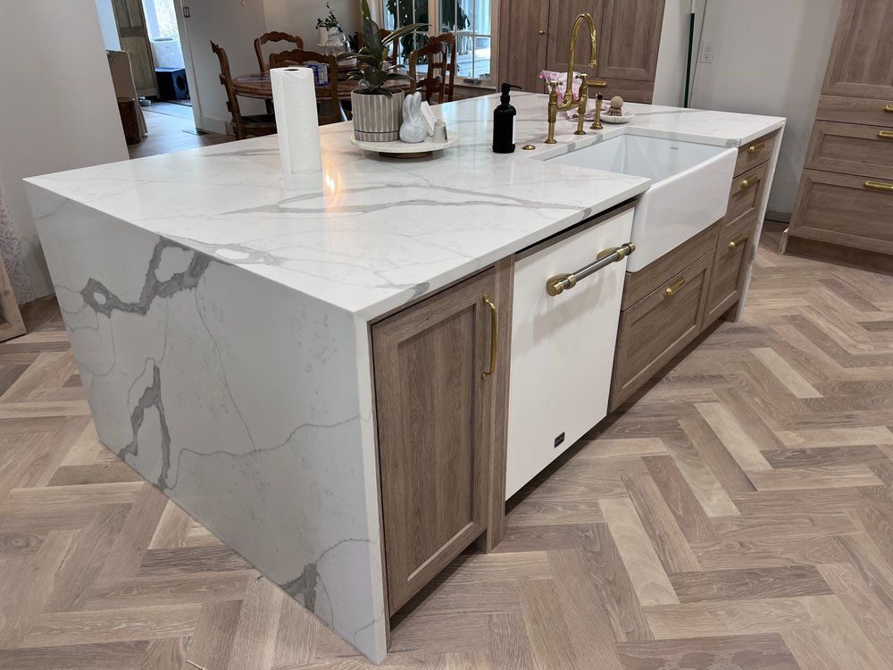 A kitchen with a large island and a sink.
