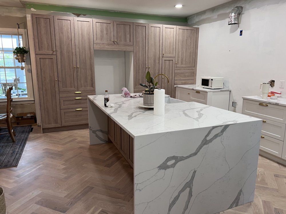 There is a large island in the middle of the kitchen.