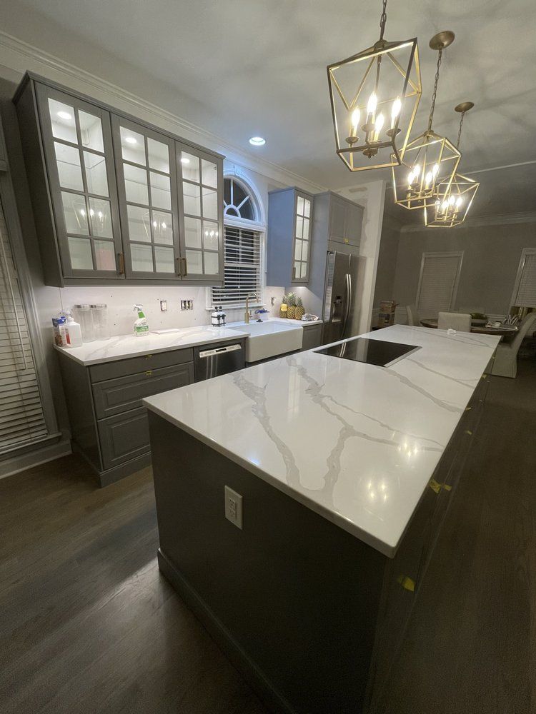 A kitchen with a large island and a sink.