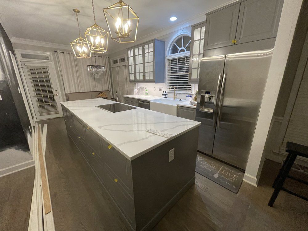 A kitchen with a large island and stainless steel appliances.