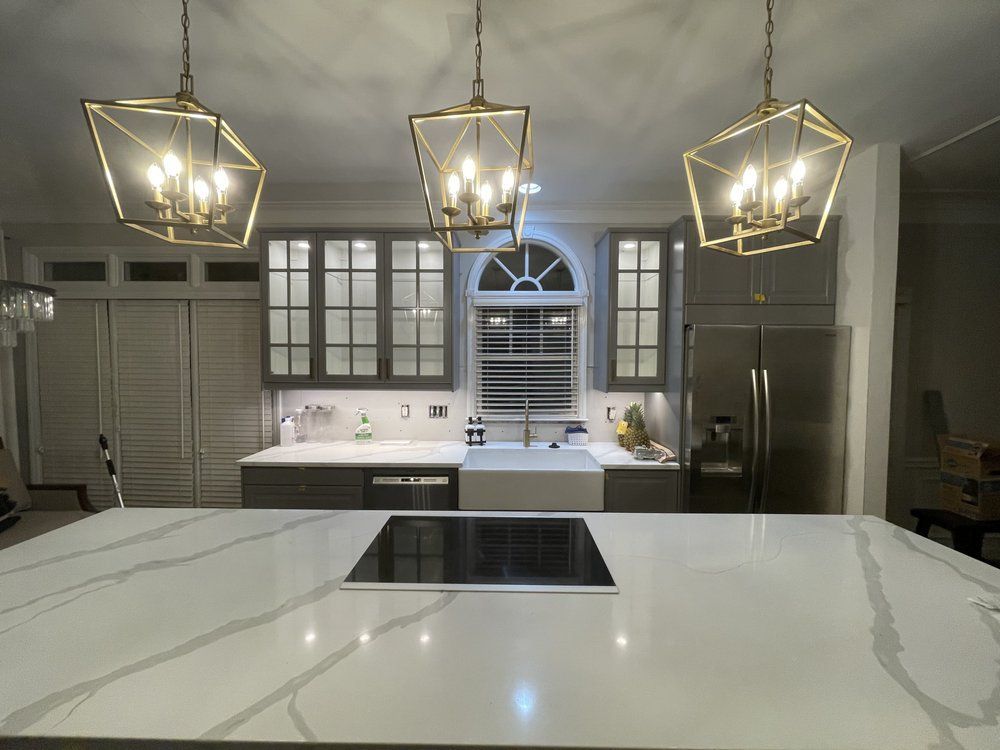 A kitchen with a large island and a stove top oven.