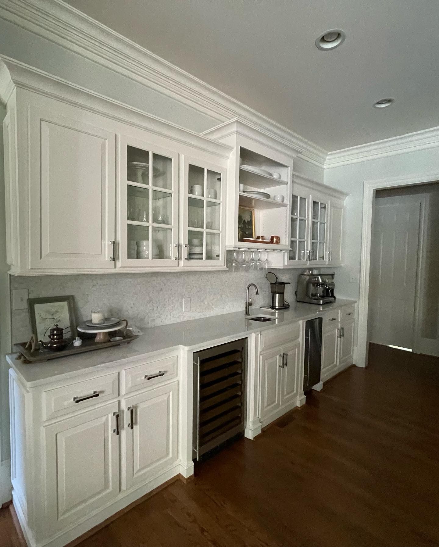 A kitchen with white cabinets and stainless steel appliances.