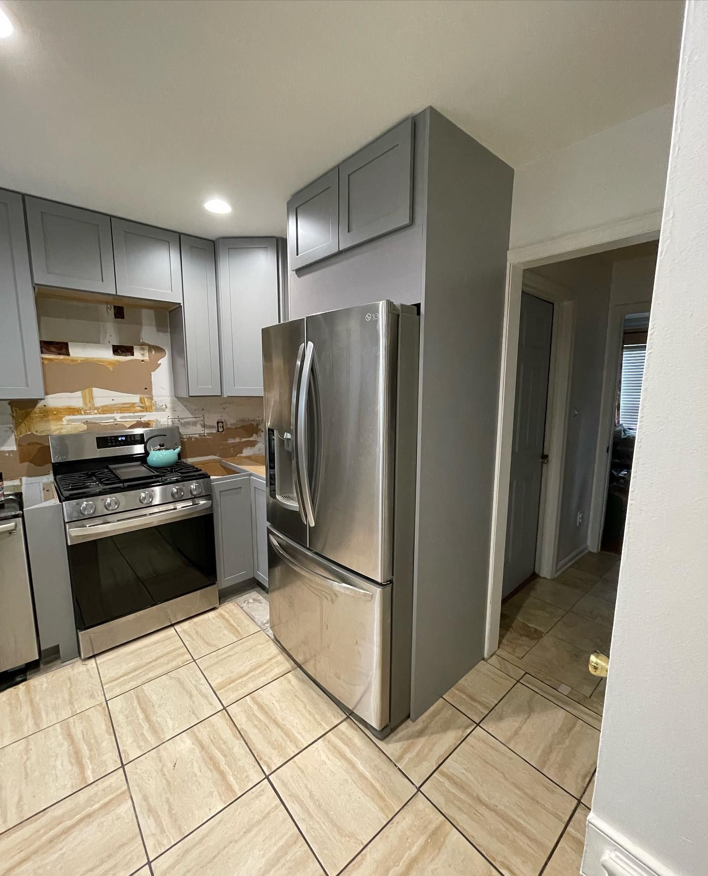 A kitchen with a stove , refrigerator , and dishwasher.