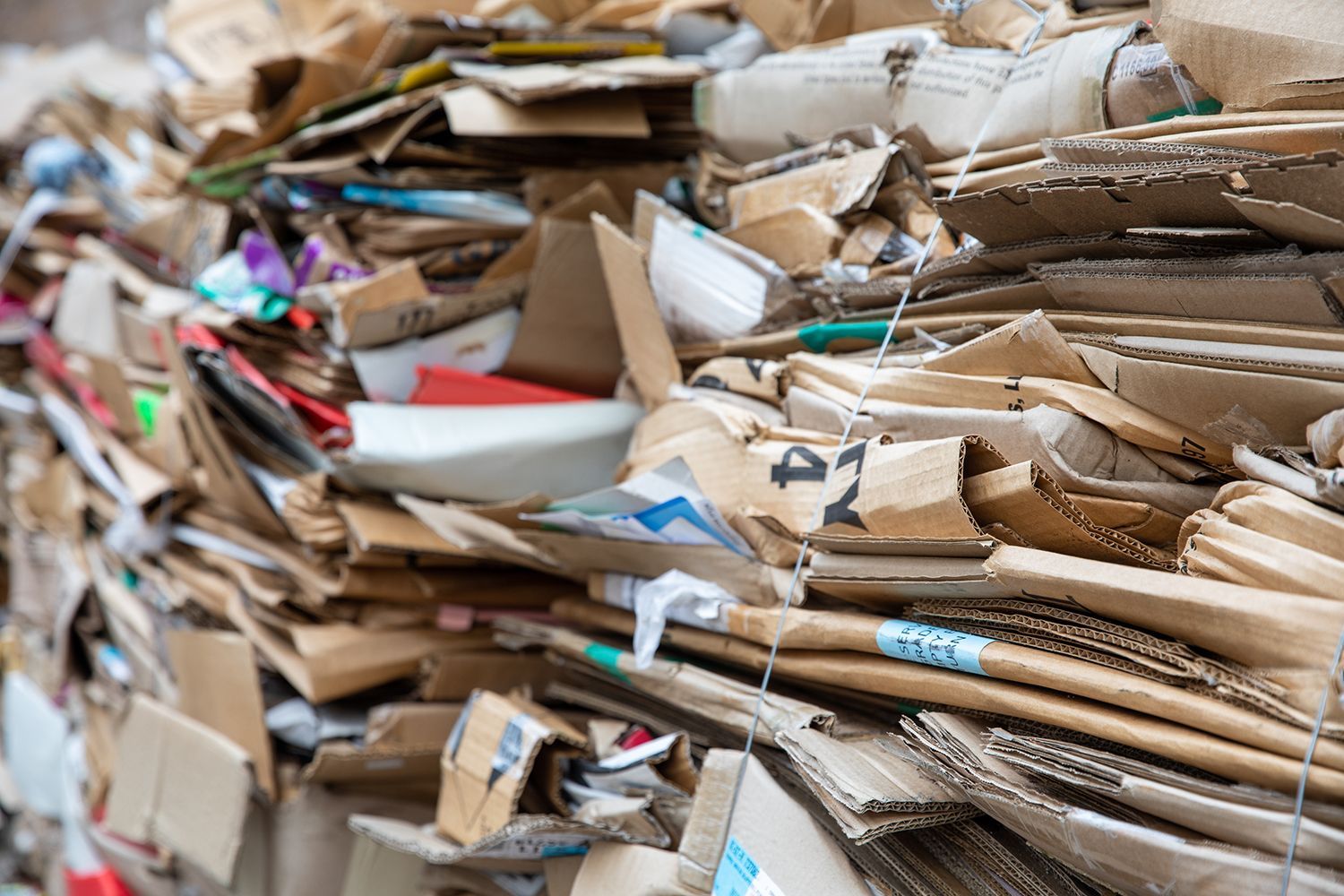 Piles of recycled cardboard ready for processing to support sustainable waste management.