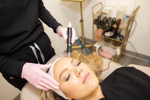 A woman is getting a facial treatment at a beauty salon.