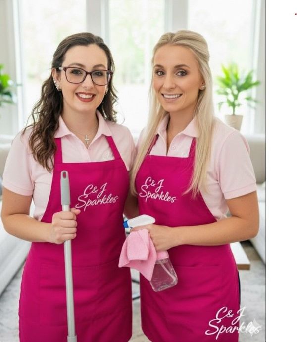 Man vacuuming carpet in a bright living room with light-colored walls and furniture.