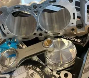 A close up of a cylinder and pistons on a table.