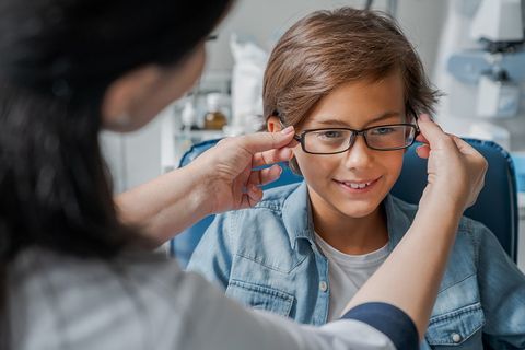 Putting Glasses on Little Boy — Chino, CA — Chino Optometry Center