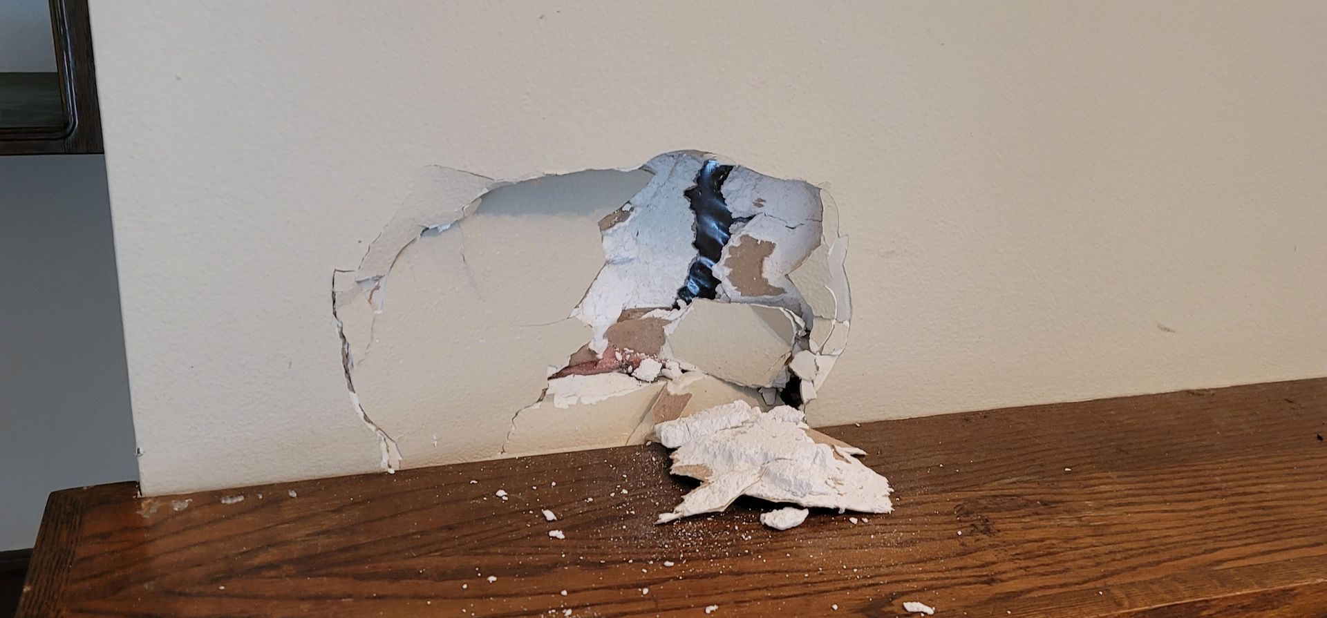 Drywall repair with sanding and patching in progress