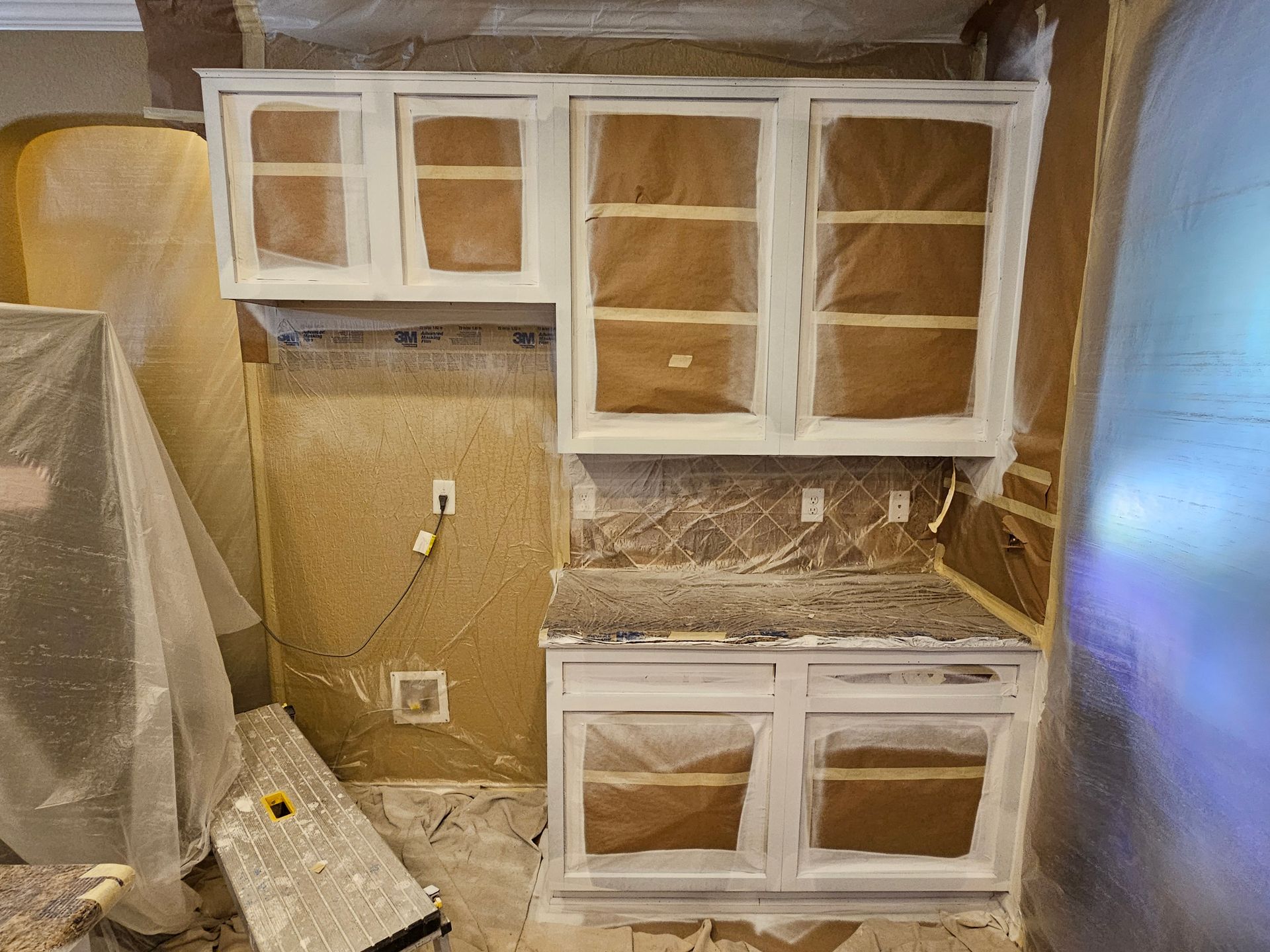 Spray-applied cabinet refinishing in a residential kitchen