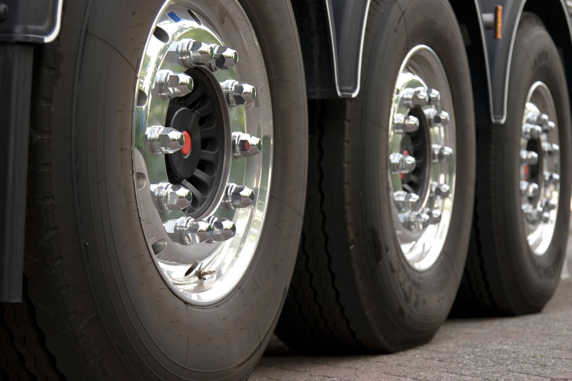 Close-up view of three truck tyres with the front tyre clearly in focus.