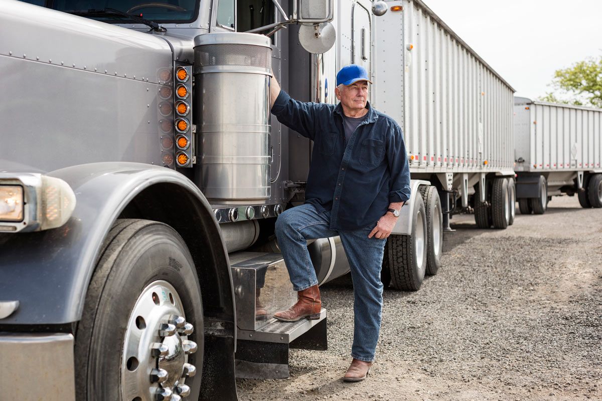 man standing by semi truck