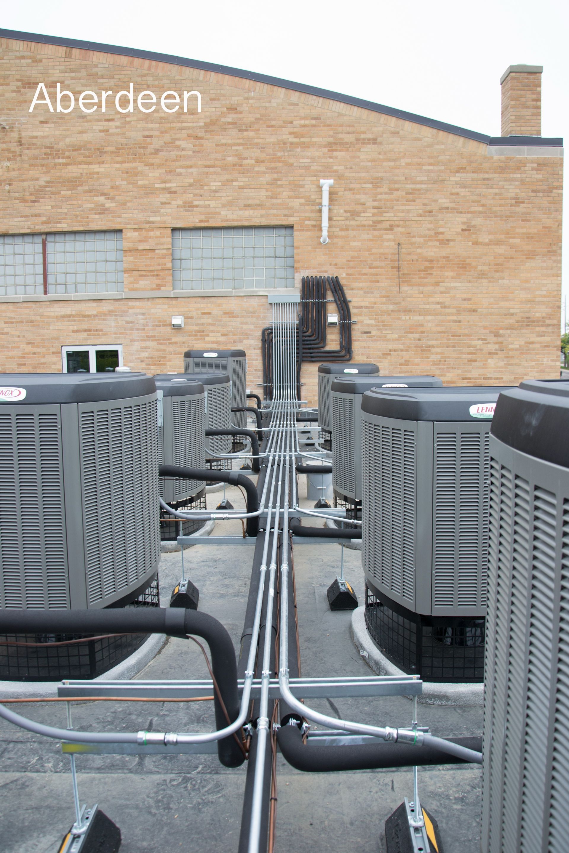 A row of air conditioners on the roof of a building in aberdeen
