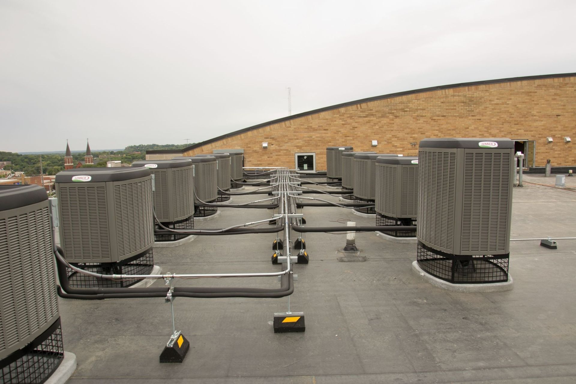 A row of air conditioners on the roof of a building