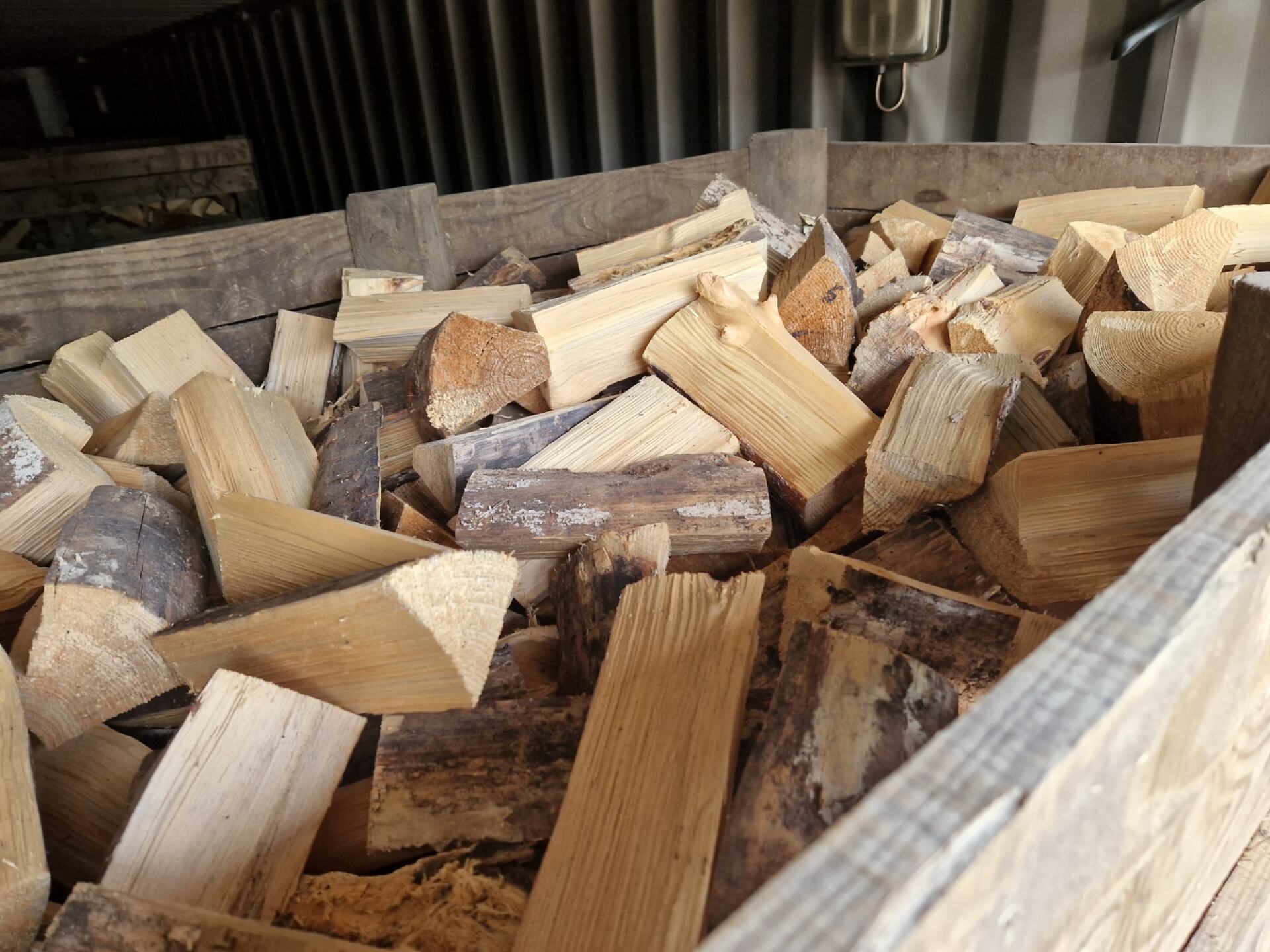 A pile of wood is sitting in a wooden box.