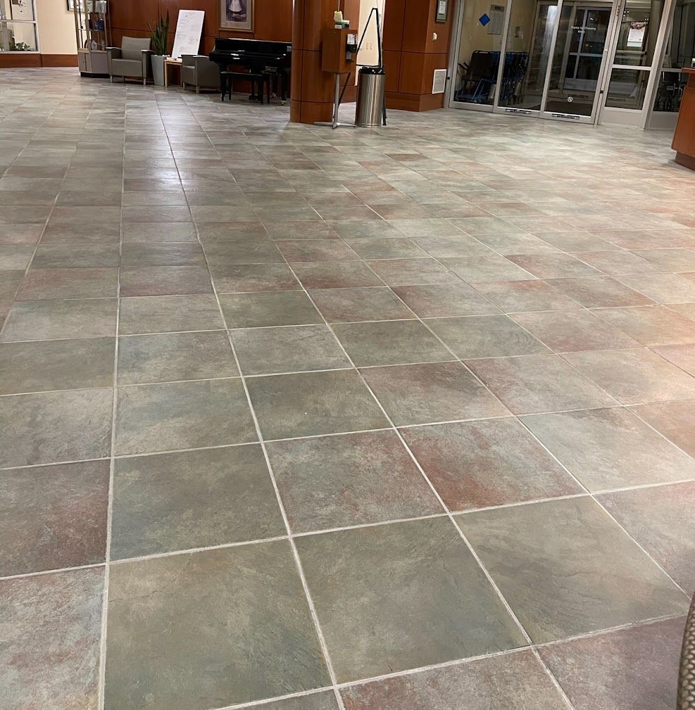 A tiled floor in a room with a lot of windows