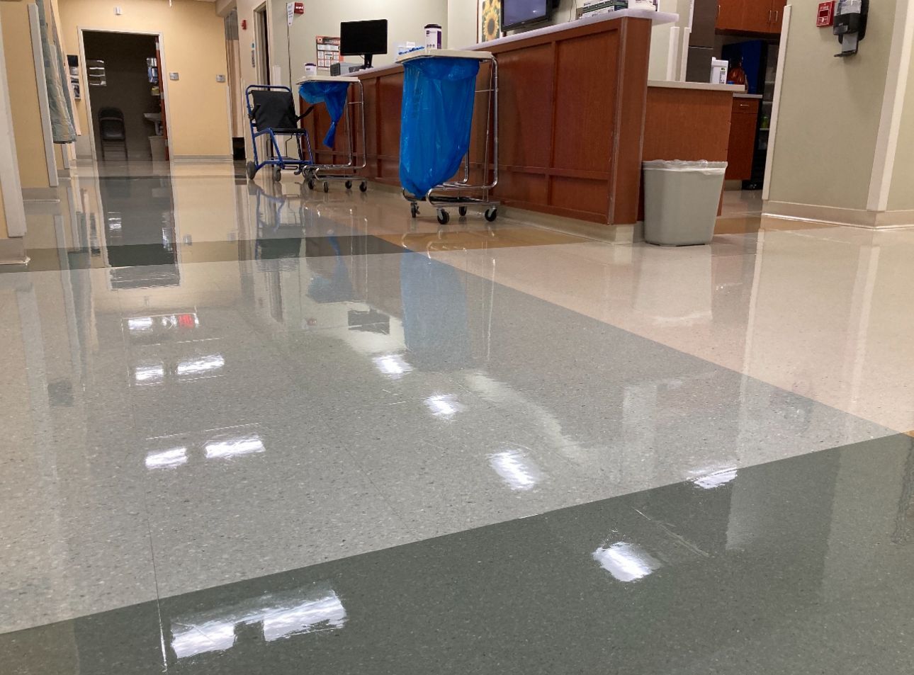 A cleaning cart with a mop and bucket in front of a building