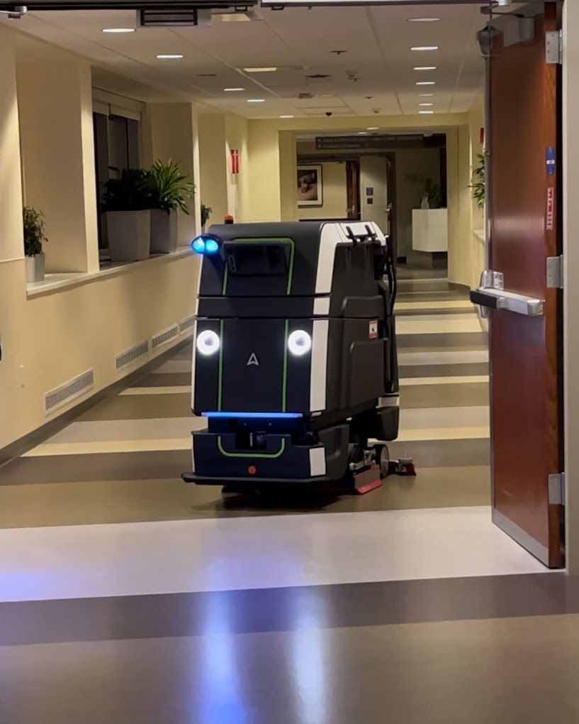 A black and white vehicle is driving down a hallway