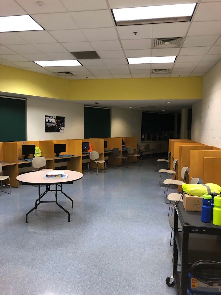 A large room with a table and chairs in it