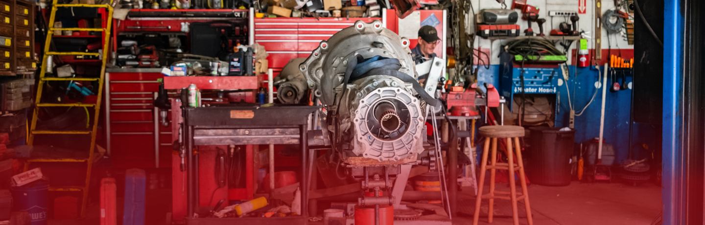 A large engine is being worked on in a garage. | White Sulphur Garage