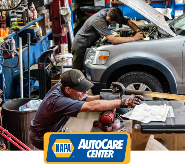 Two men are working on a car in a napa autocare center | White Sulphur Garage