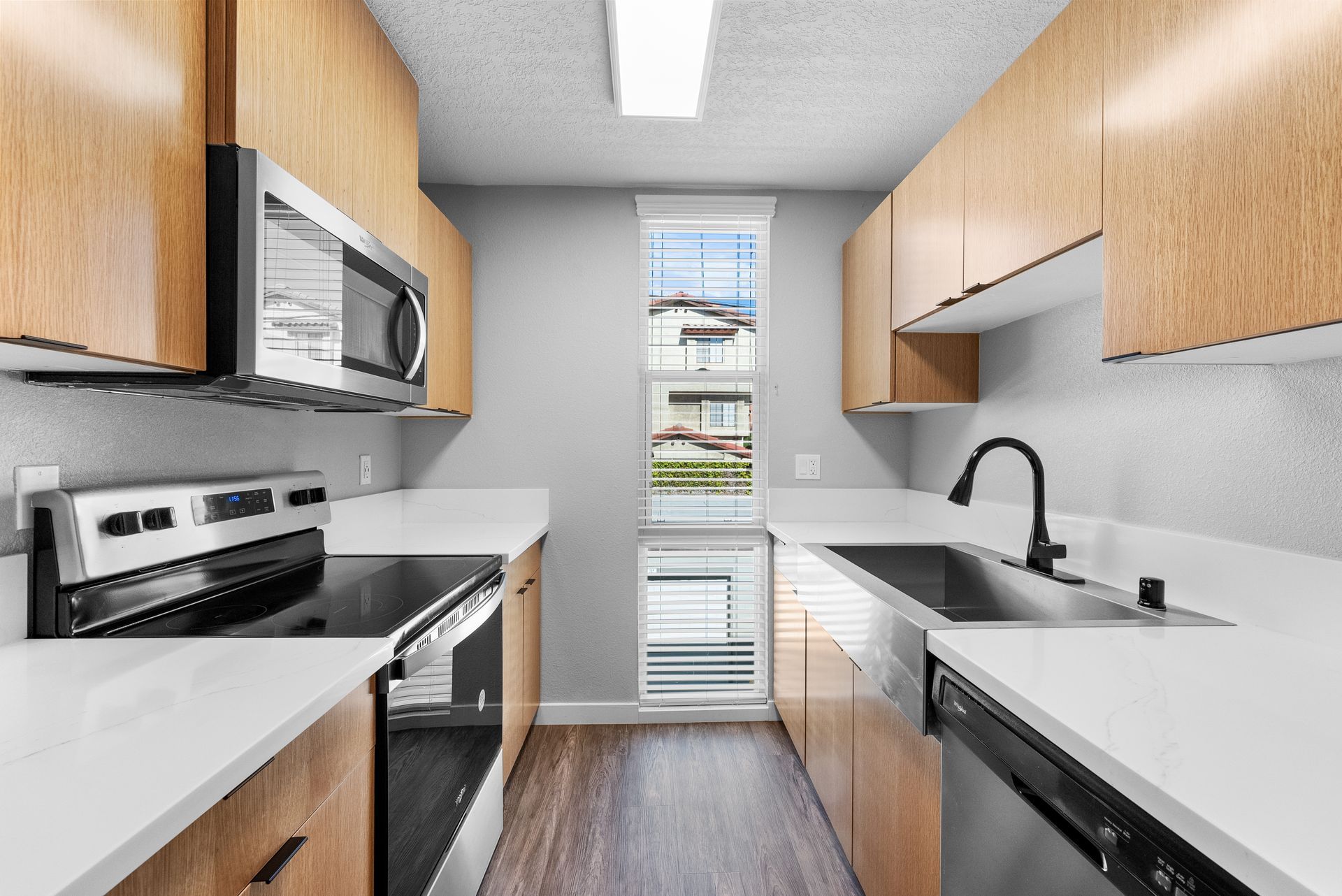 kitchen with sink, stove, and microwave