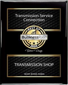 A black and gold plaque for transmission service connection and transmission shop