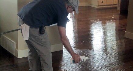 Man spraying wood floor solutions - Carpet Cleaning in Colbert, WA