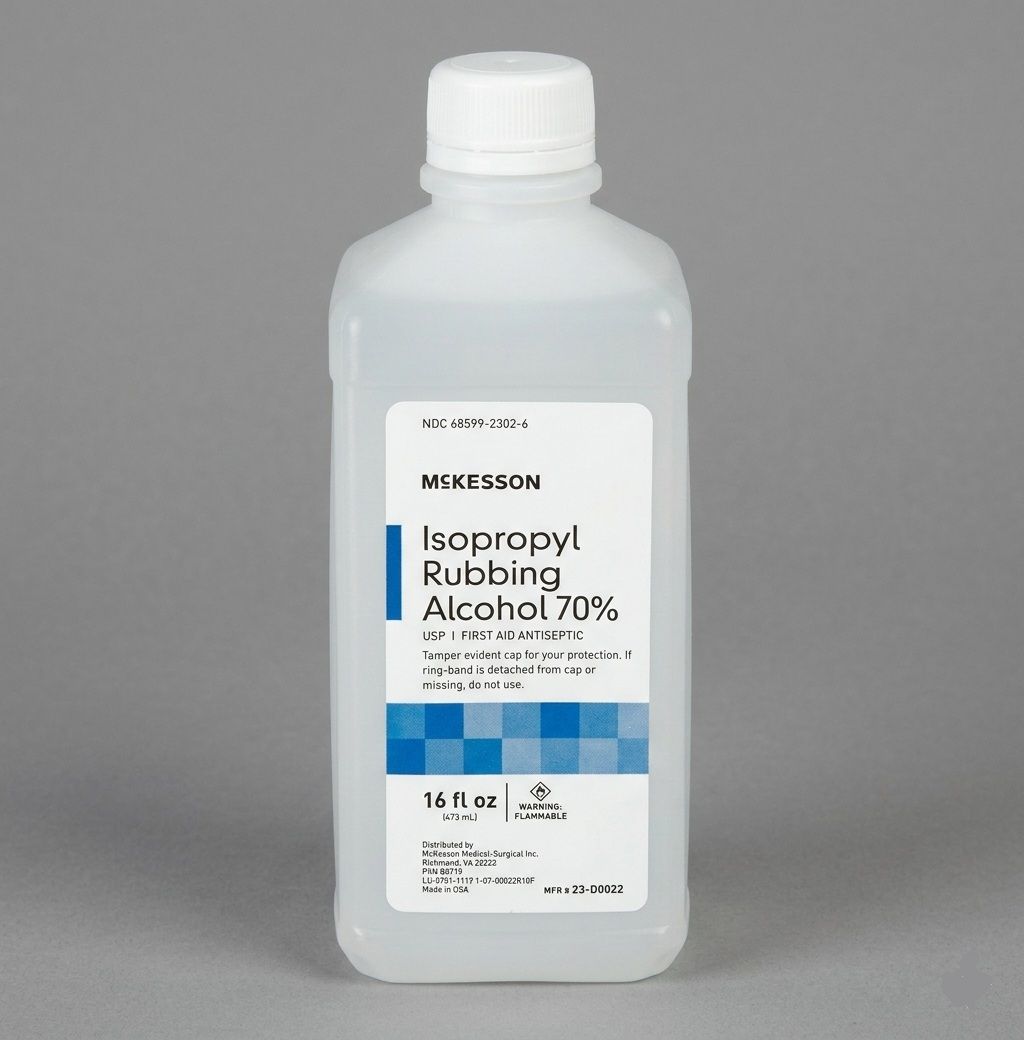 Hands spraying pruning shears with a bottle, pink flowers in the background.