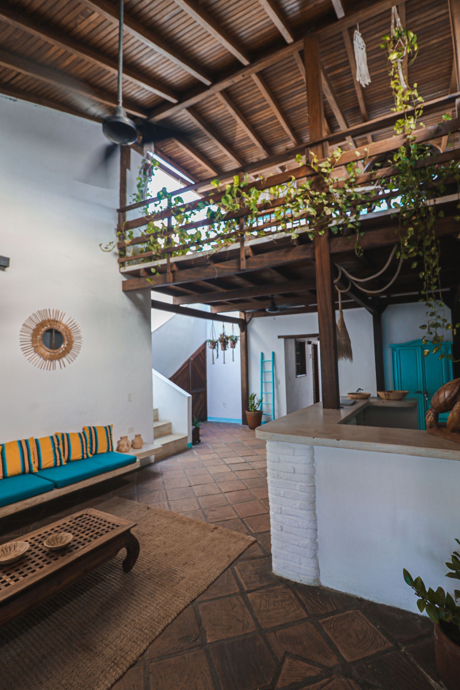 A living room with a couch , table , and ceiling fan.