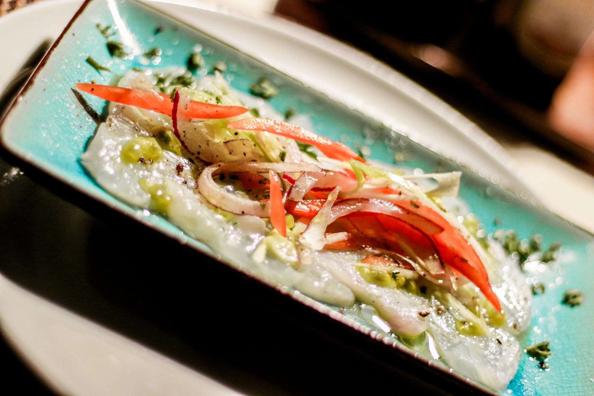 A close up of a plate of food with vegetables on a table.