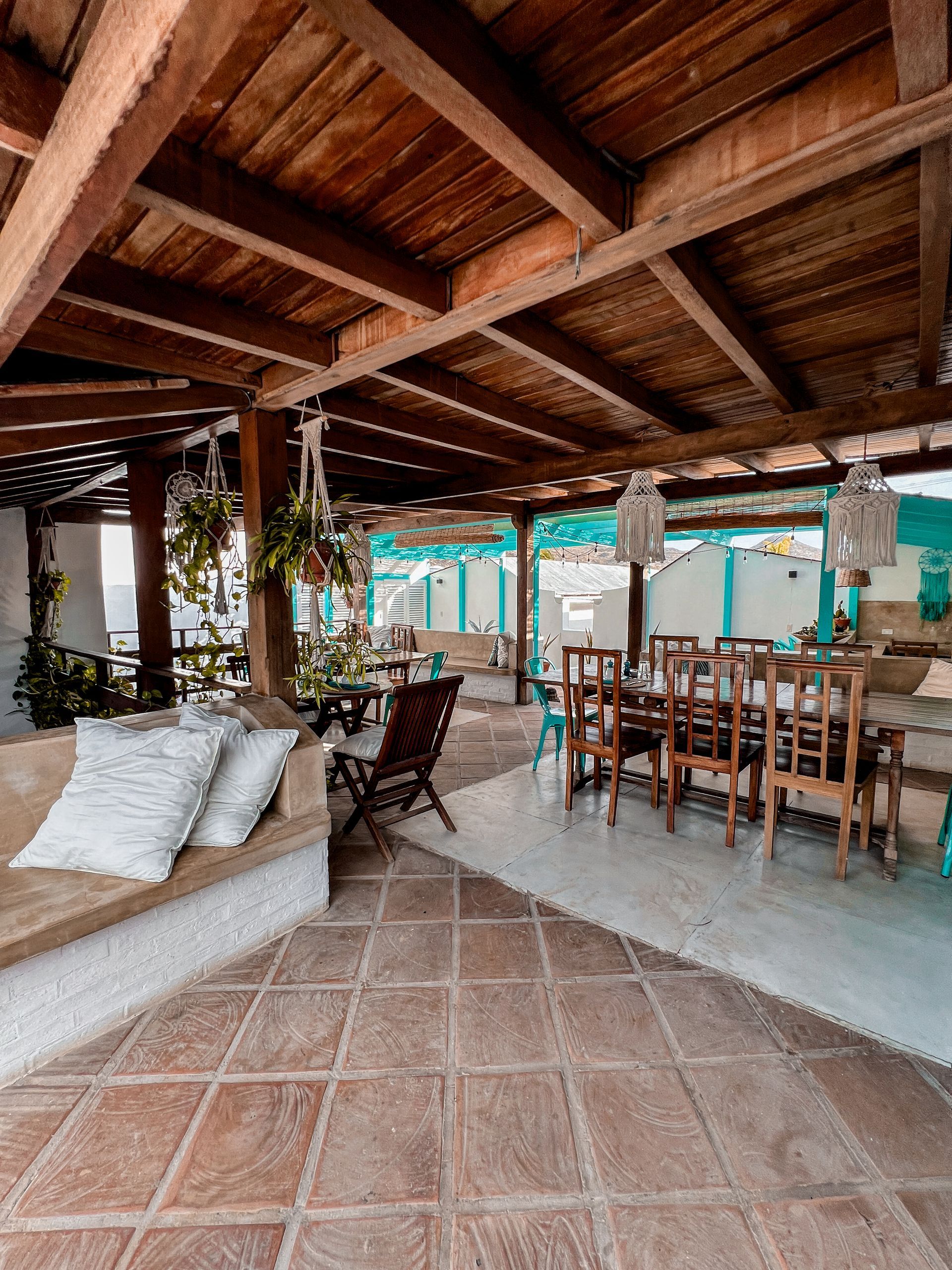 A large room with a wooden ceiling and a dining table and chairs.