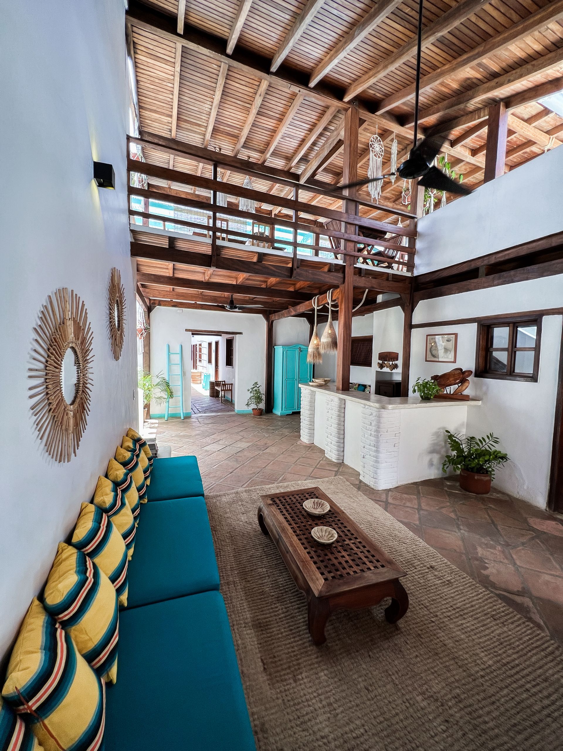 A living room with a blue couch and a wooden coffee table.