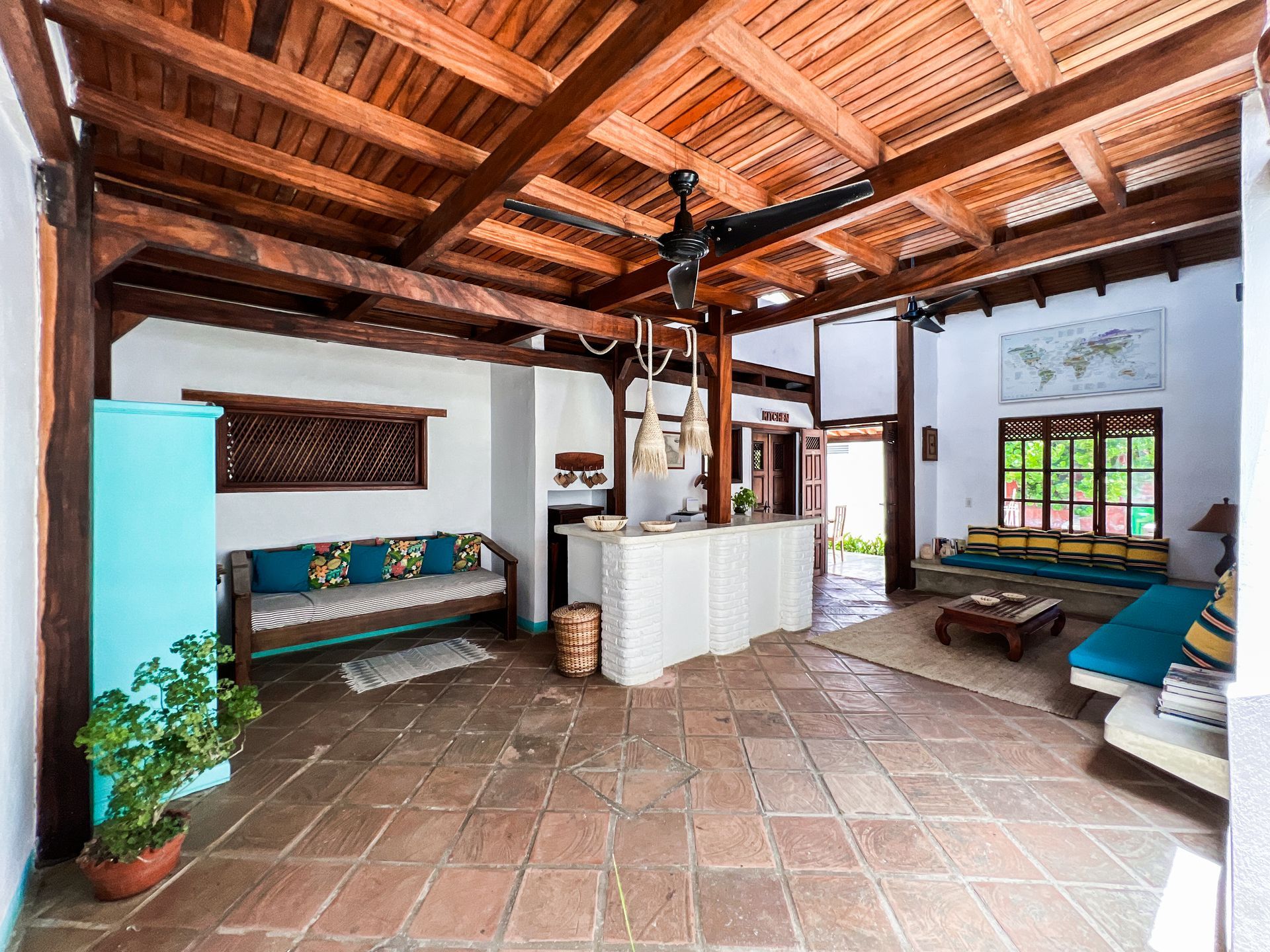 A living room with a wooden ceiling and a couch.