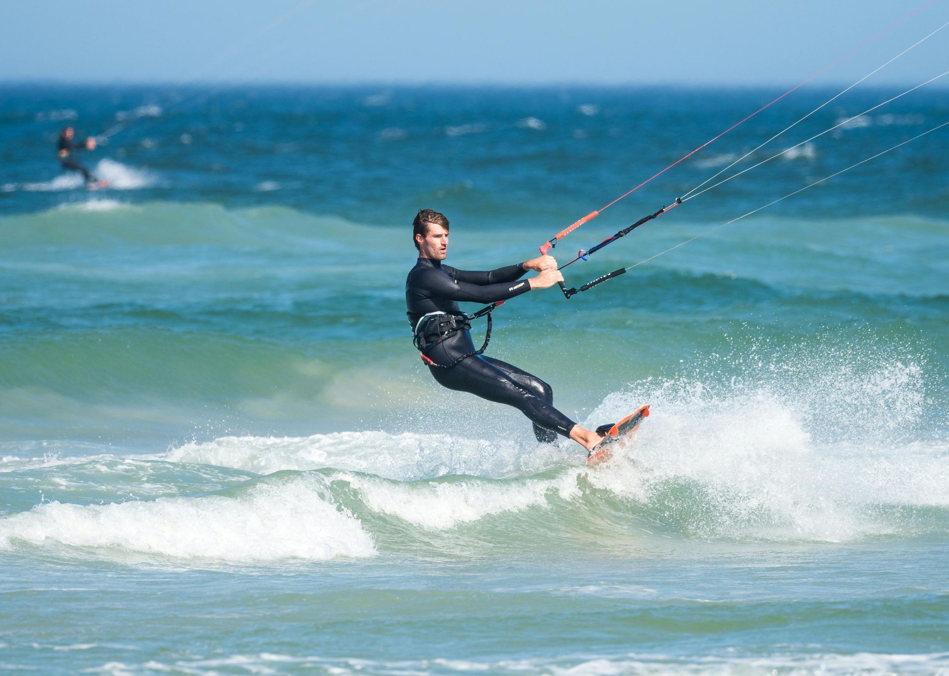 A man is riding a wave on a surfboard in the ocean.