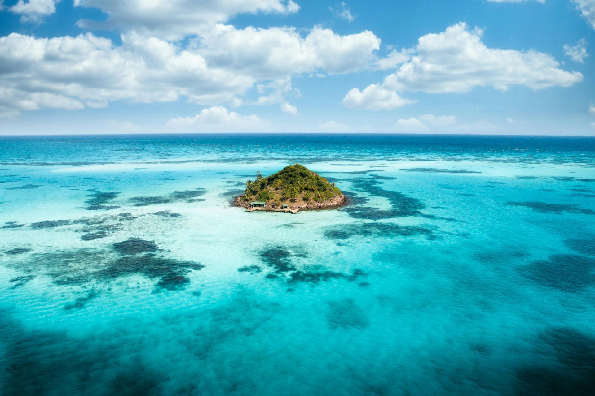An aerial view of a small island in the middle of the ocean.