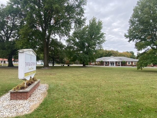 Front signage with grass and view of Bodine Chapel Day & Genda Funeral Home in IN.