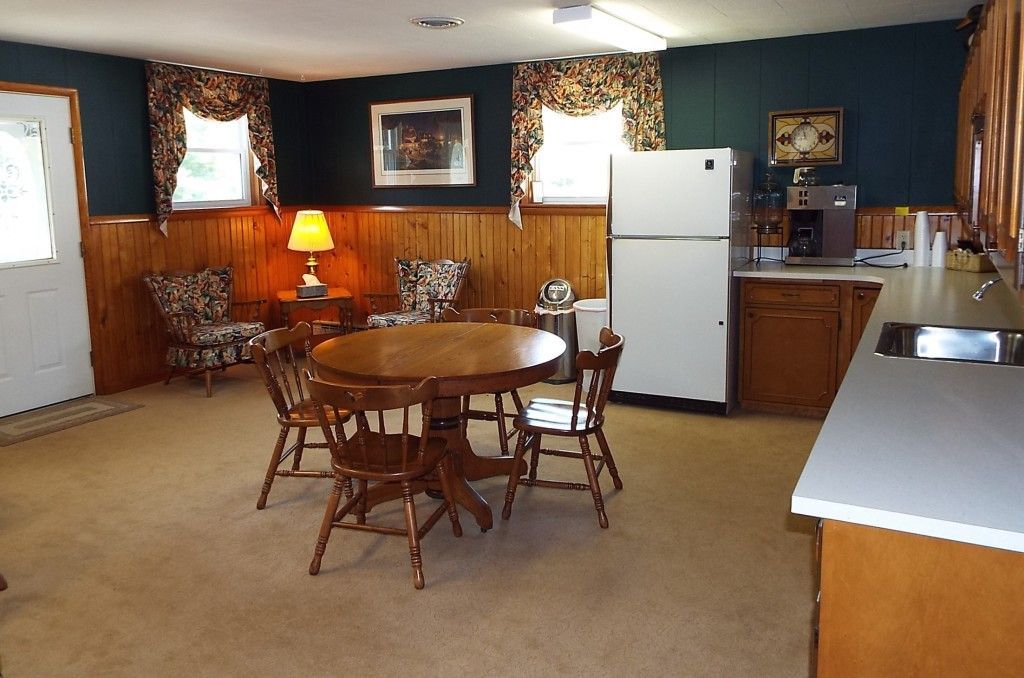 a kitchen with a table and chairs and a refrigerator
