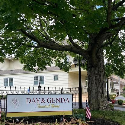 a funeral home with a sign in front of it for Day & Genda Funeral Home Frankfort location