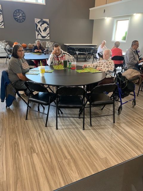 a group of people are sitting at tables playing bingo