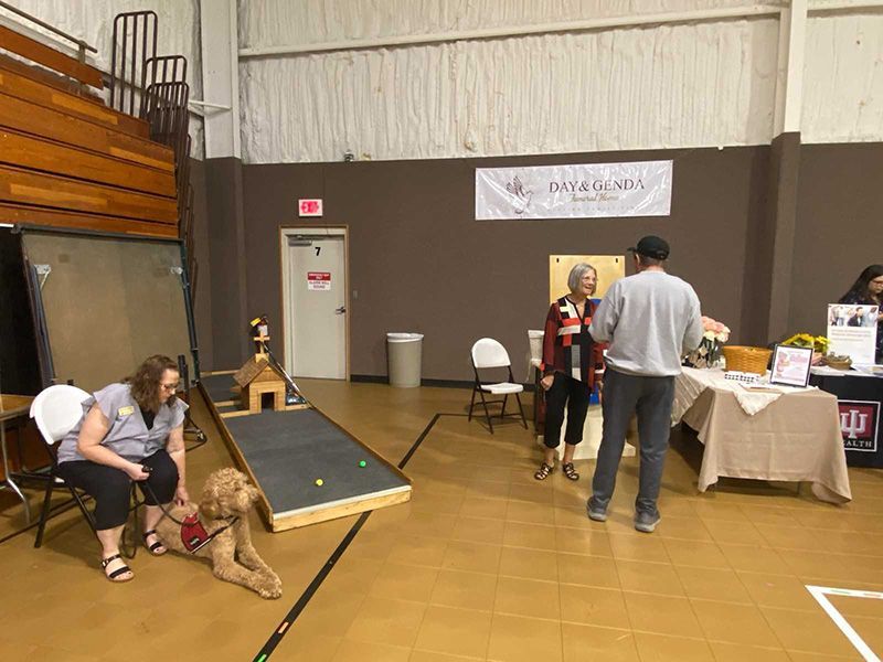 Several photos of Norm the Grief Dog with Day and Genda Funeral Home