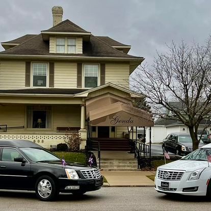 two cars are parked in front of Day & Genda Funeral Home Frankfort location