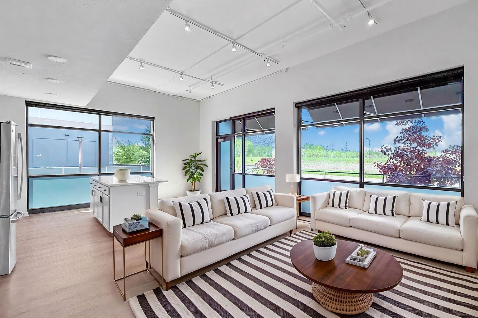 Ample living area for two love seats or couches in new walk up homes with street access