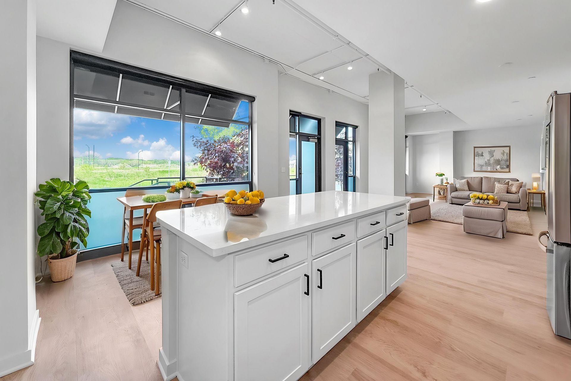 Great room like space with kitchen, kitchen island, and living area